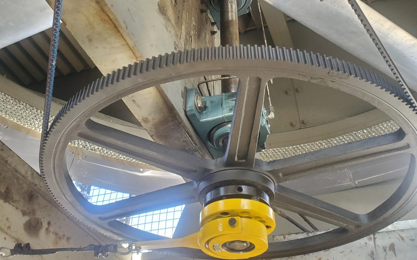 A yellow DG-II® Anti Rotation Device fitted to the pulley bushing of an air cooler fan drive
