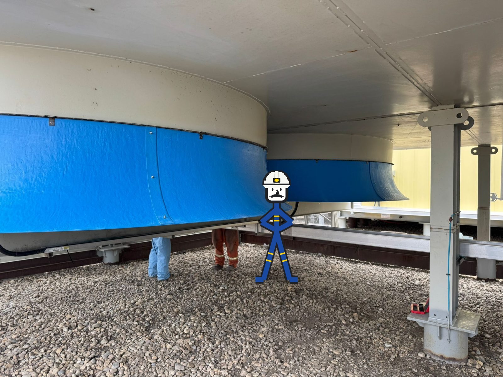 Two fiberglass inlet bells installed side by side under an air cooler, with the crew working beneath