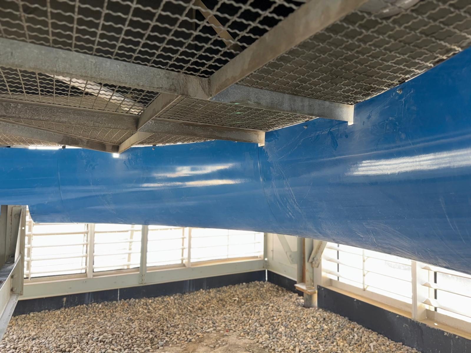 Blue fiberglass elliptical inlet bell installed under an air cooler fan deck