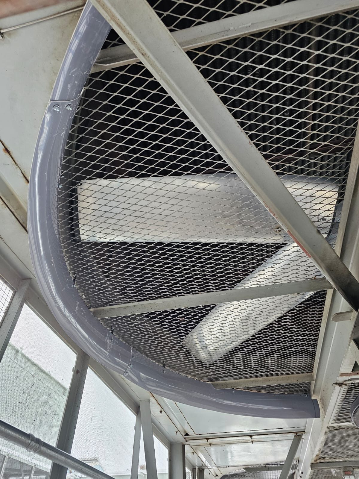 Grey inlet bell ring fitted beneath the fan guard of an air cooler